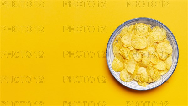 Top view chips bowl yellow background. Resolution and high quality beautiful photo