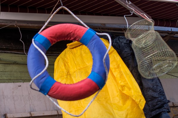 Lifesaver or life preserver with rope around for a drowning person to grab