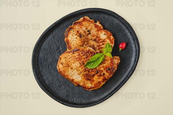 Overhead view of fried chopped pork tenderloin on a plate