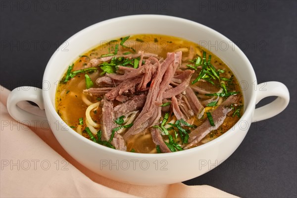 Plate of beef soup with pieces of meat