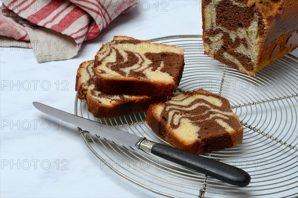 Marble cake and knife on cake rack