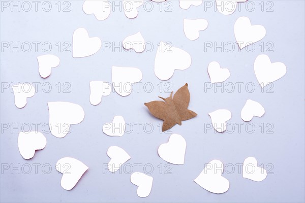 Paper butterfly and paper hearts in red color