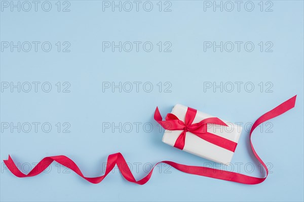 Red ribbon near gift box