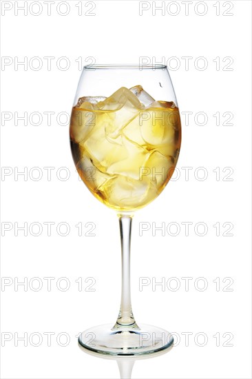 Apple cocktail with a sparkling wine with ice cubes in wine glass isolated on white
