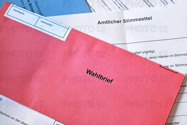 Red German postal voting envelope with German text saying 'voting letter' on ballot paper