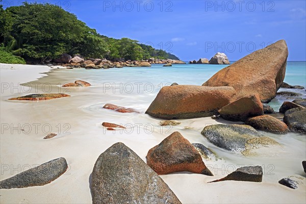 Granite rocks and beach of Anse Lazio in the evening