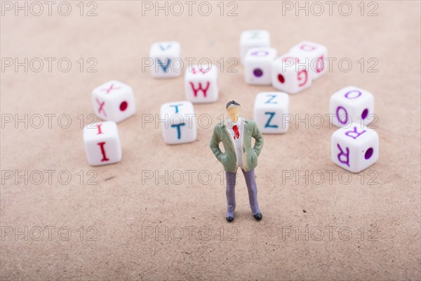 Figurine standing in front of the colorful alphabet letter cubes