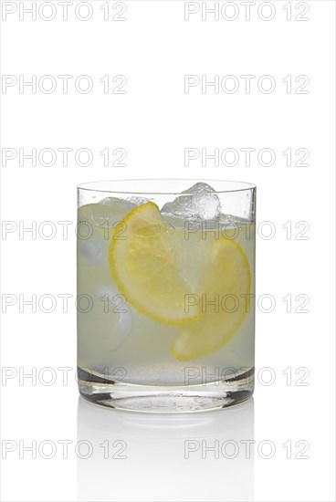 Cocktail martini and tonic with lemon and ice isolated on white
