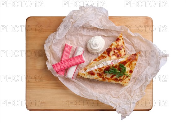 Top view of thin pancakes stuffed with soft cheese and crab meat isolated on white