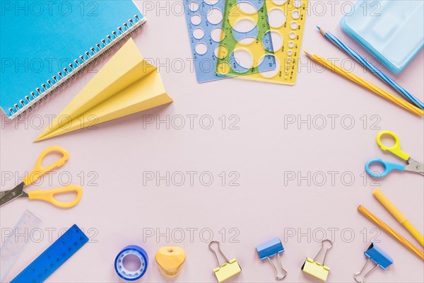 Pink background with school supplies