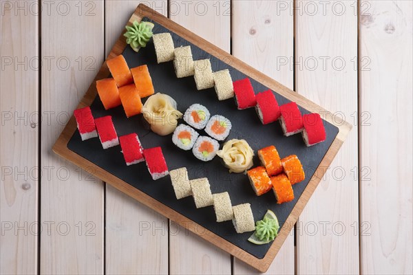 Big set of rolls served on stone plate