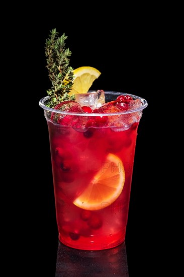 Cranberry vodka cocktail with lemon and rosemary isolated on black