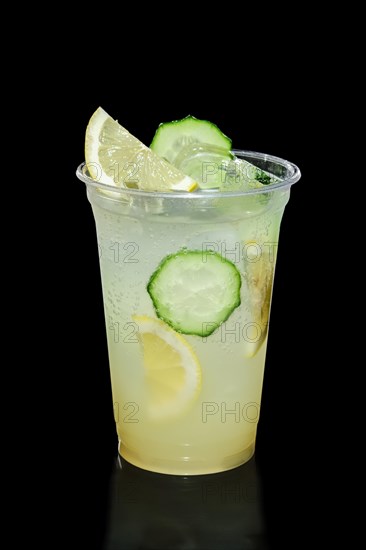 Take away glass with lemon and cucumber lemonade isolated on black