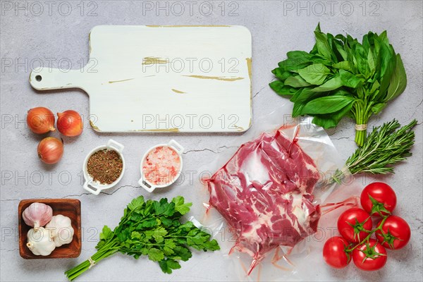 Vacuum sealed lamb shoulder with ingredients for cooking