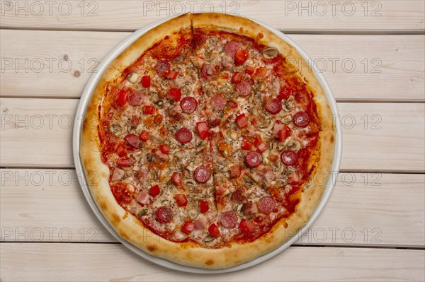 Top view of pizza pepperoni on wooden table