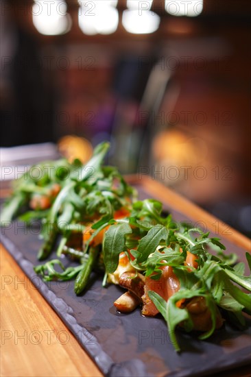 Smoked salmon with mushroom and bean decorated with ruccola. Photo taken with shallow depth of field