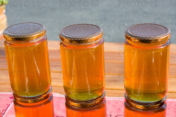 Glass jar of full of fresh honey with lid