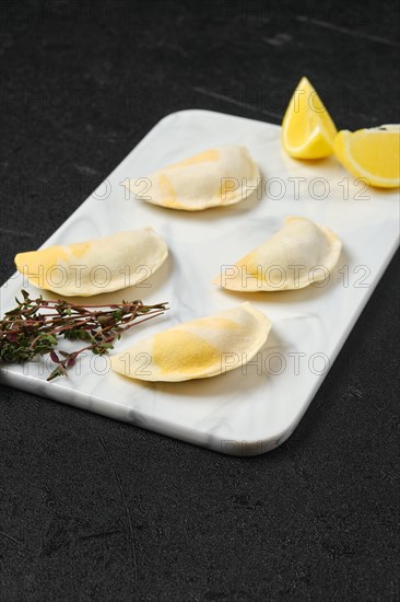 Semifinished frozen salmon dumplings on serving board