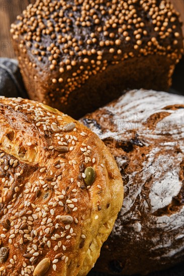 Closeup view of assortment of cereal bread made of different seeds on wooden table