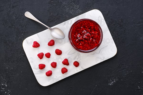 Top view of transparent pot with raspberry jam