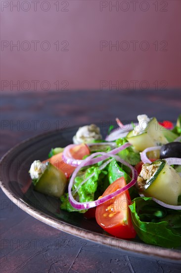 Fresh salad with zucchini stuffed with feta cheese with tomato