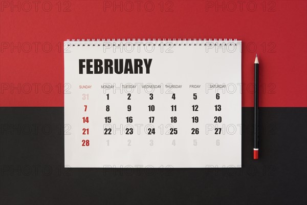 Flat lay planner calendar red black background