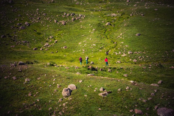 Hikers with backpacks and trekking poles walking in Turkish highland