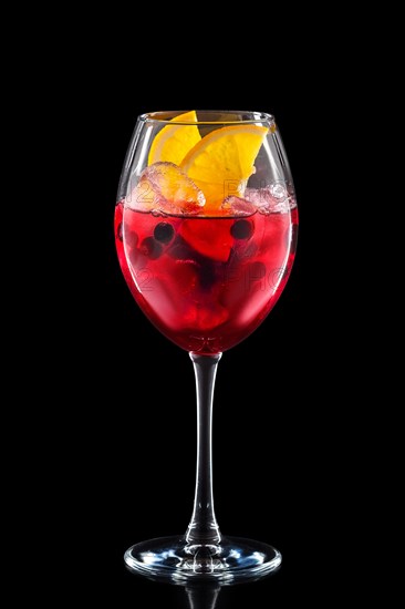 Cold sangria in a wine glass isolated on black background