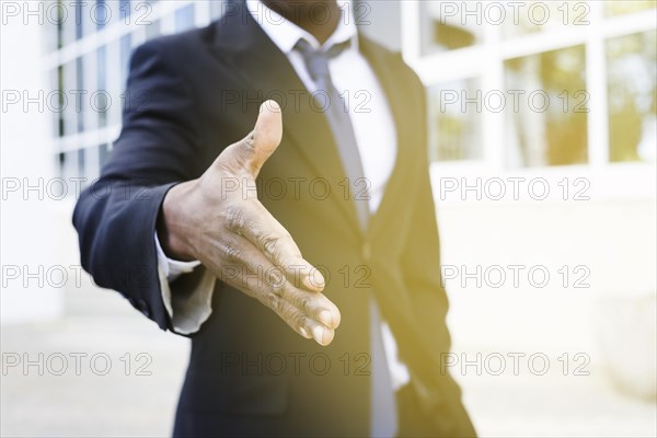 Elegant businessman reaching out hand