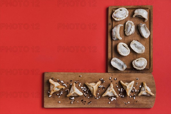 Traditional tibetan momo dumpling triangular shape wooden tray against red backdrop. Resolution and high quality beautiful photo