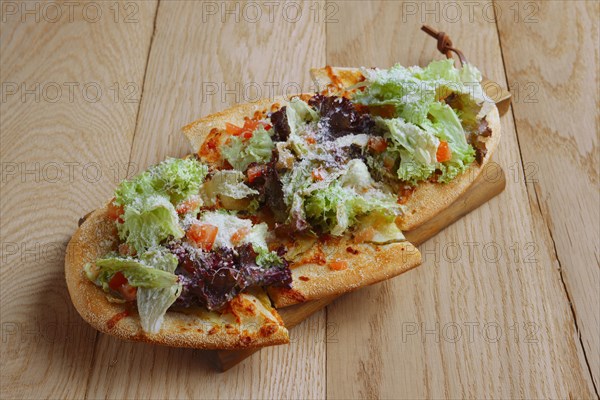 Freshly baked focaccia with salad leaves