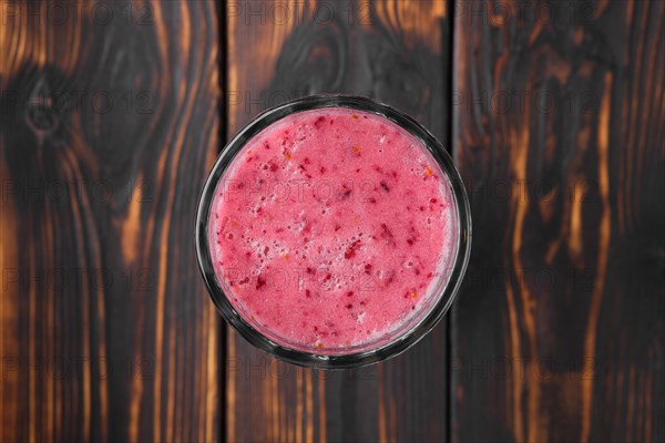 Top view of black currant and raspberries smoothie