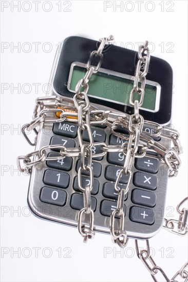 Calculator wrapped in chains on a white background