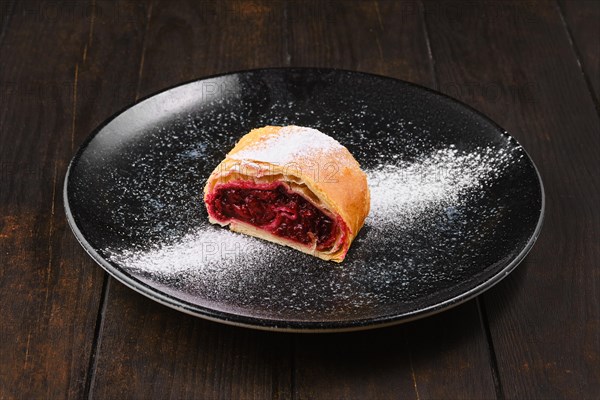 Piece of classic cherry strudel on a plate