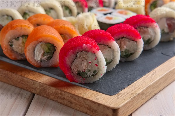 Big set of rolls served on stone plate