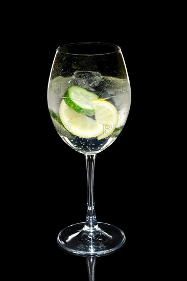 Cold lemon and cucumber cocktail in wine glass