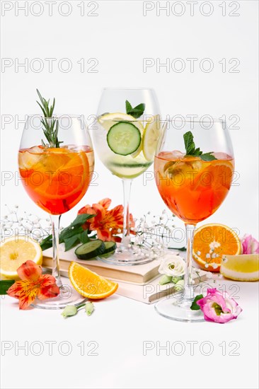 Three pitchers with summer fruit and berry cocktails on white background
