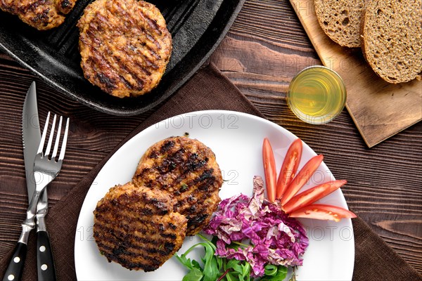 Top view of country dinner with cutlet and fresh salad