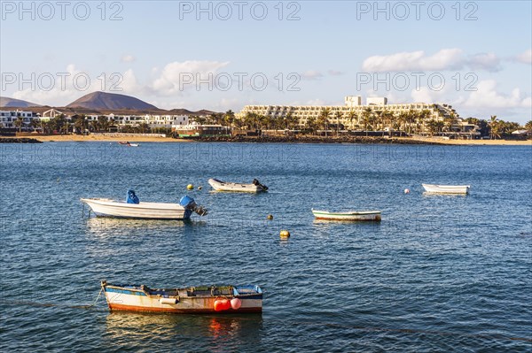 View of the resort town named Costa Teguise with boats on the foreground