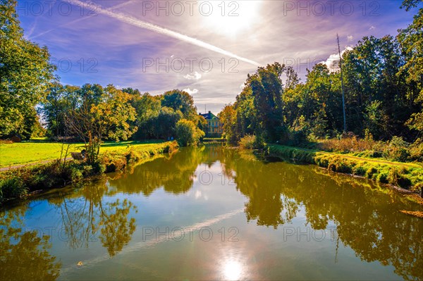 Hagenburg Canal with view to Hagenburg Castle in autumn with blue sky and sunshine