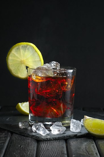 Rum and cola cocktail on dark background