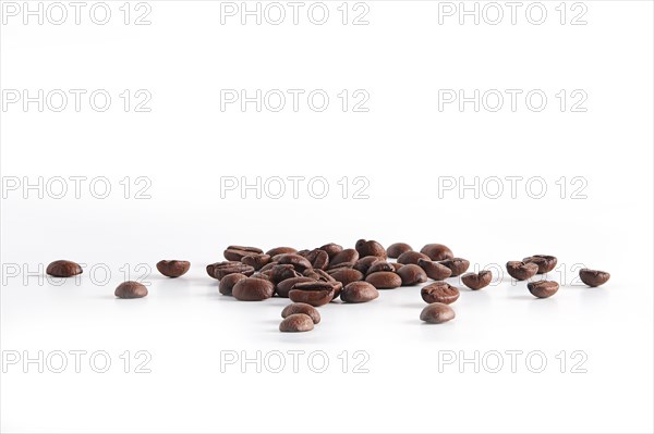 Coffee beans scattered on white background