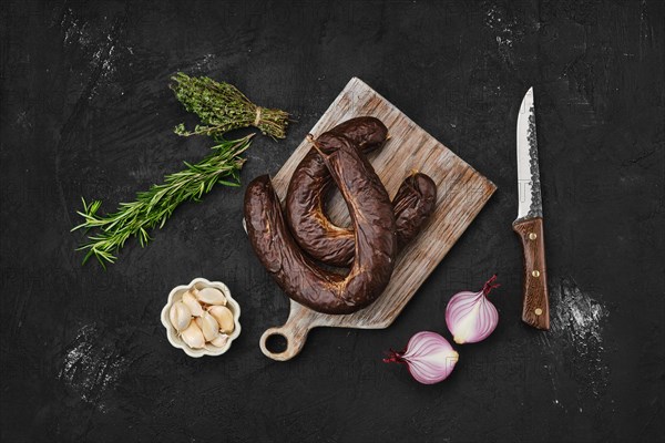 Overhead view of organic blood pudding on cutting board