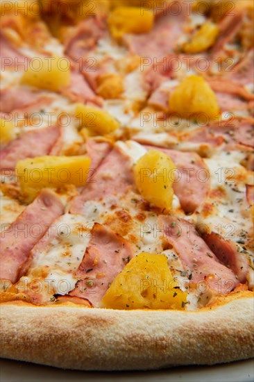 Macro photo of pizza with chicken ham and pineapple