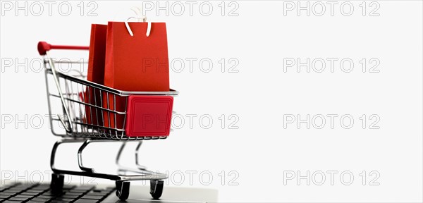 Front view shopping card with bags copy space cyber monday