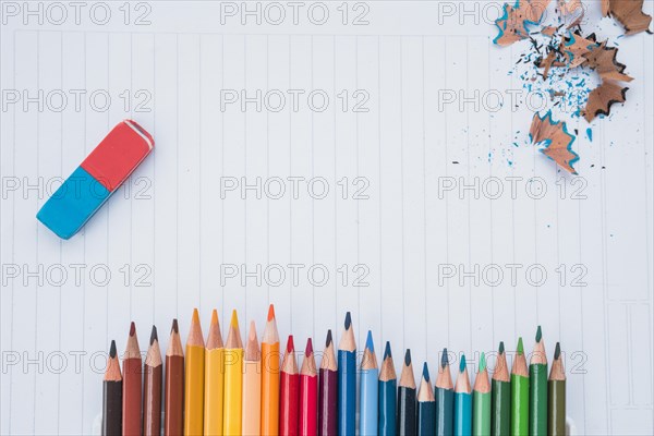 Row pencil colors with eraser pencil shaving white paper