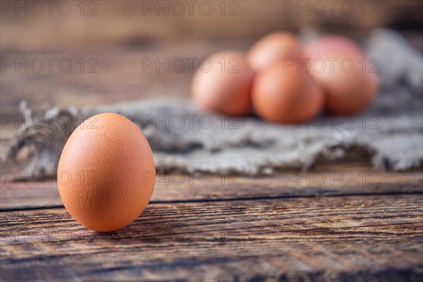 Close up view of brown chicken eggs on wooden table
