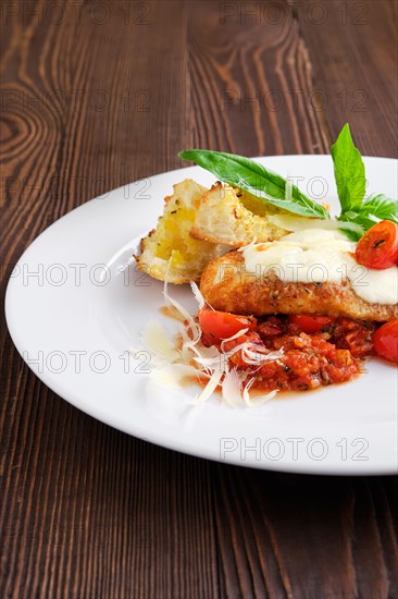 Closeup view of roasted chicken fillet with tomato cherry