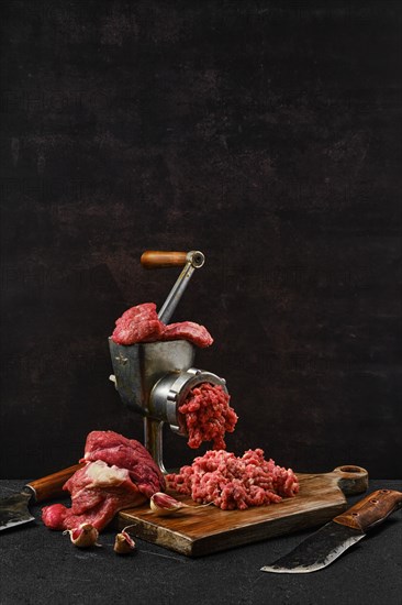 Making minced beef meat with oldfashioned meat grinder