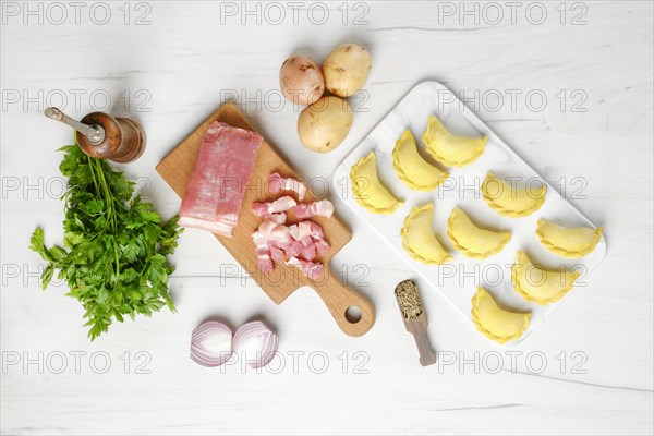 Top view of frozen dumplings with bacon and potato